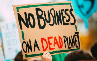 Cartaz a dizer No Business on a Dead Planet