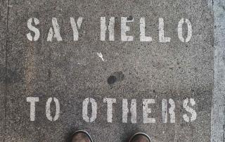 concrete floor with phrase "say hello to others"